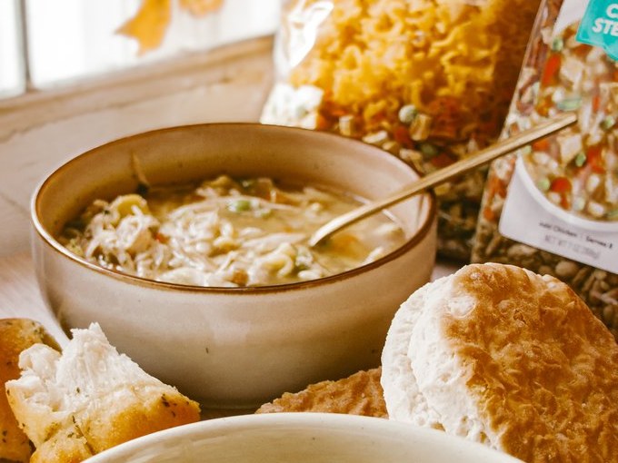 A bowl of Frontier Soups chicken noodle soup with biscuits and soup mix bags